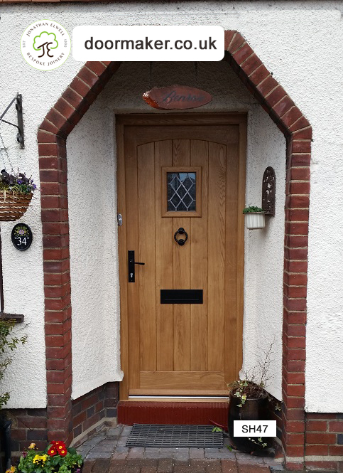 oak cottage door with swept head and vision panel